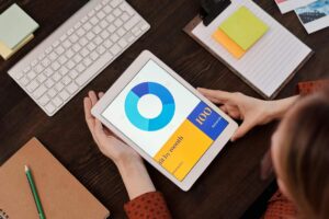 Digital agency reviewing business charts on tablet